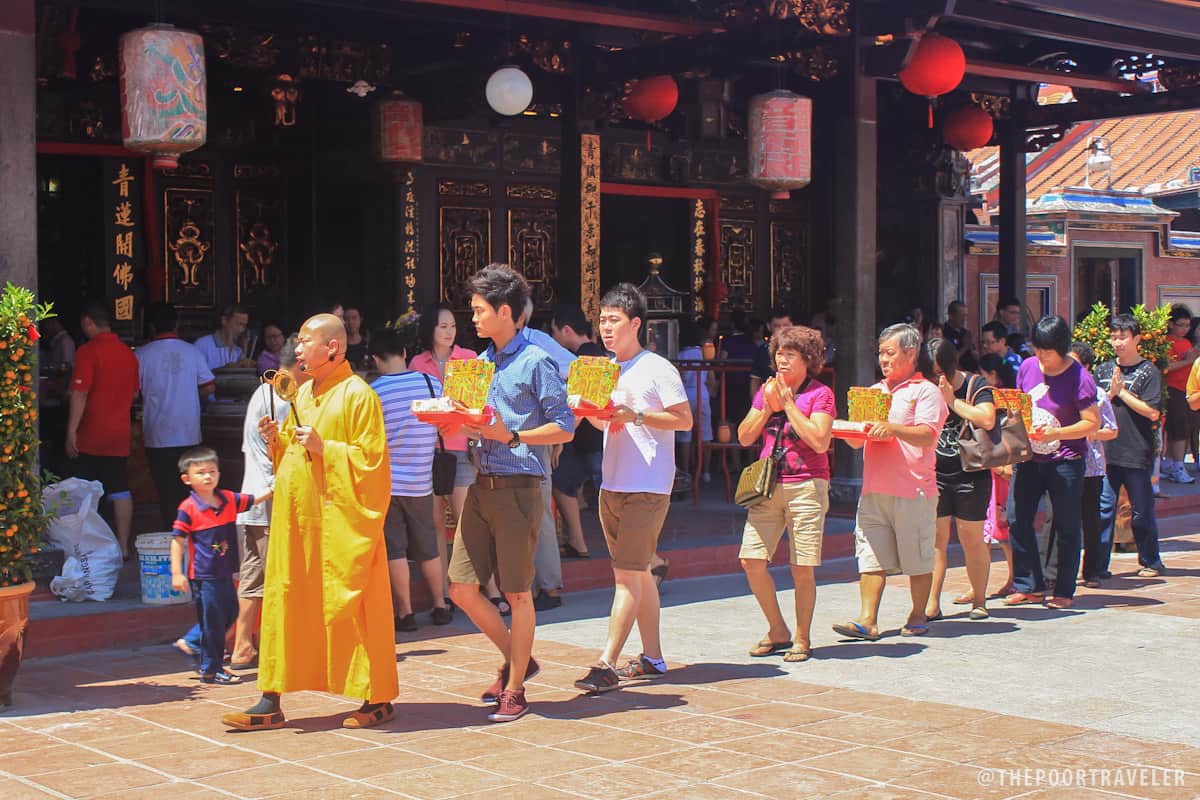 A monk leads a single-file procession