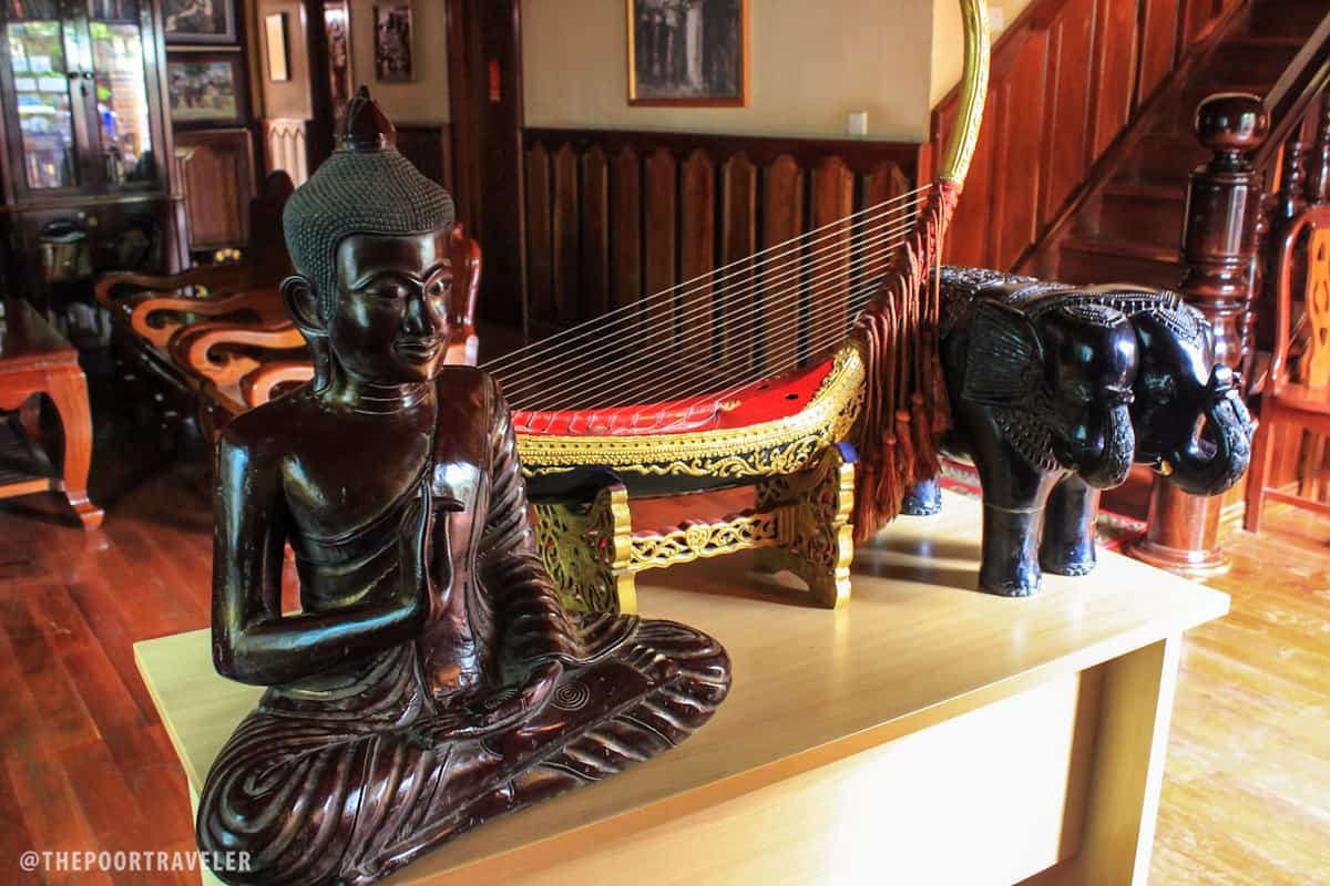 A wooden image of Buddha at the common area