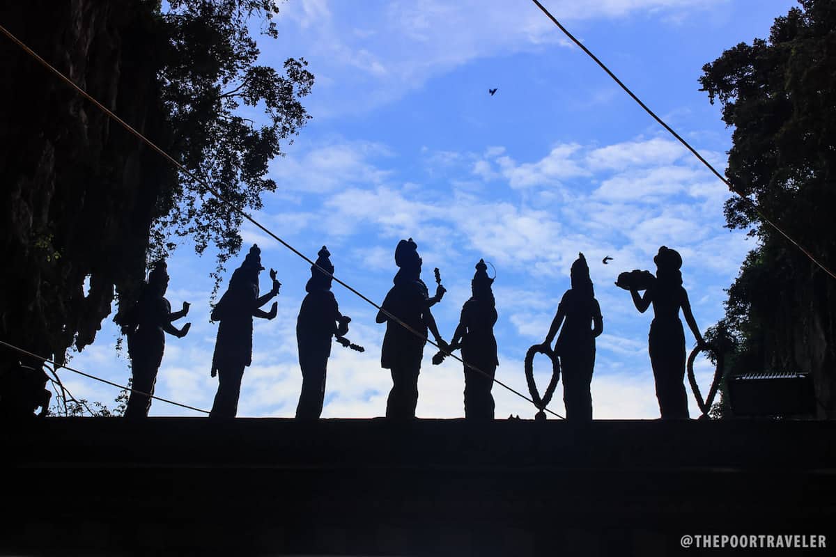 Silhouettes of figures of deities at the entrance to Temple Cave