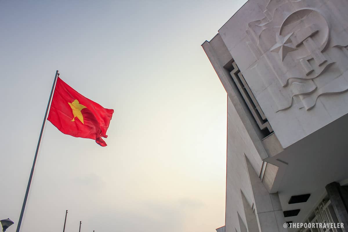 The Vietnamese flag waving proudly in front of Ho Chi Minh Museum