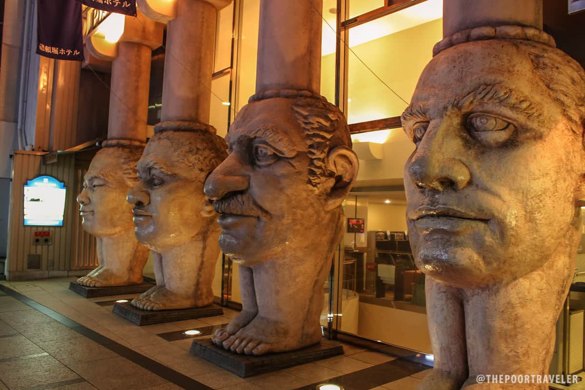 The legs have faces. These are the colonnade of Dotonbori Hotel