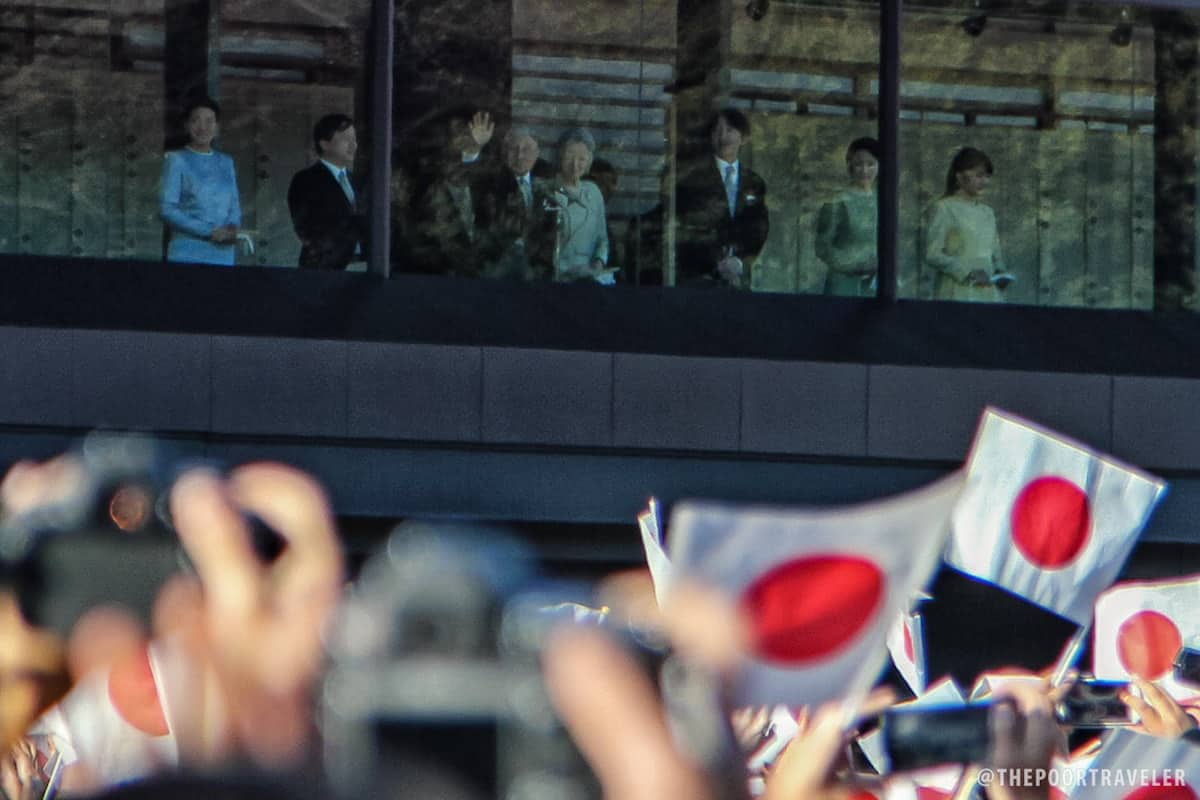 Emperor Akihito and Empress Michiko waved back at the crowd.