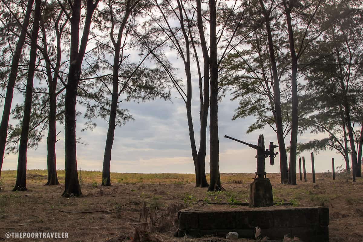 A water pump in the middle of the woods, by the beach