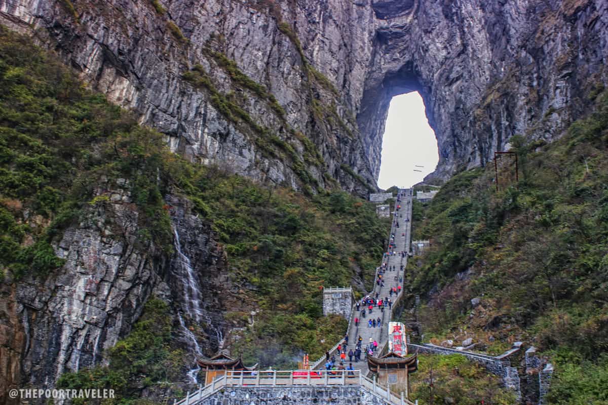 A waterfall cascades just next to the 999-step stairway to Tianmen Cave.