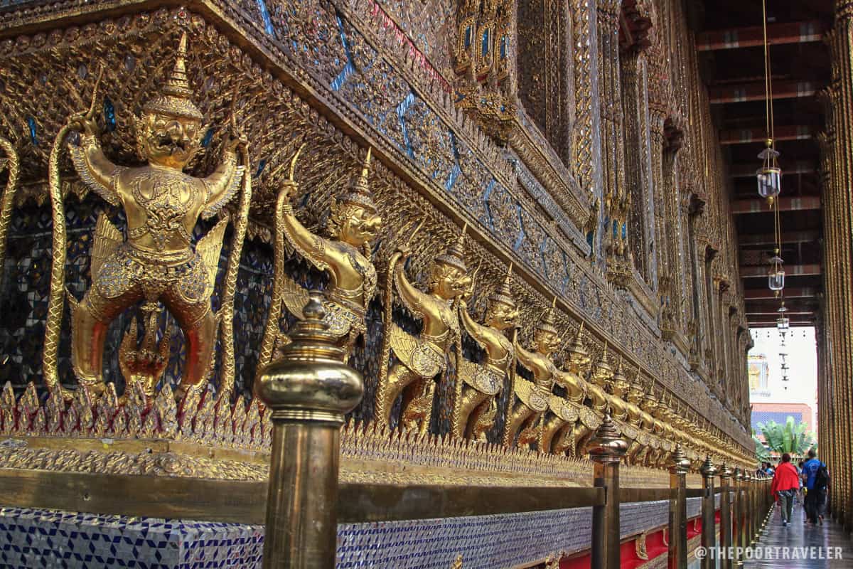 Images of garuda (mythical bird-like creatures) wrap Phra Ubosot, the temple's main building. Each garuda holds a naga, a snake deity.