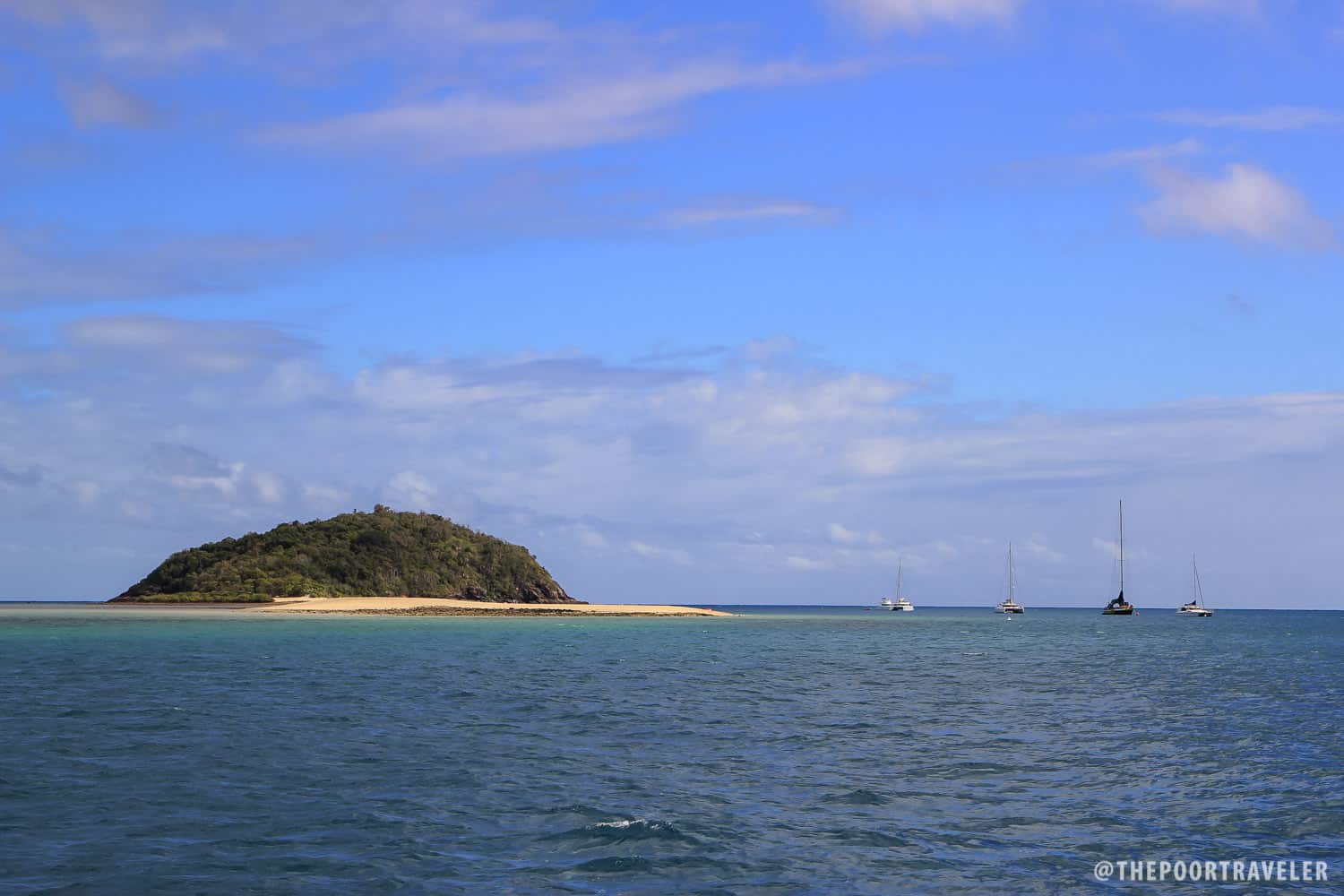 Langford Island and more sailboats moored off its coast.