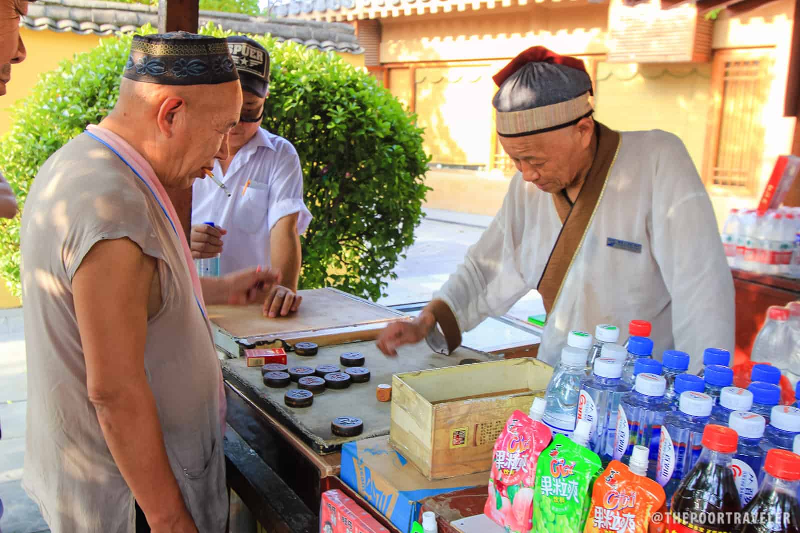 A stall vendor playing a board game.