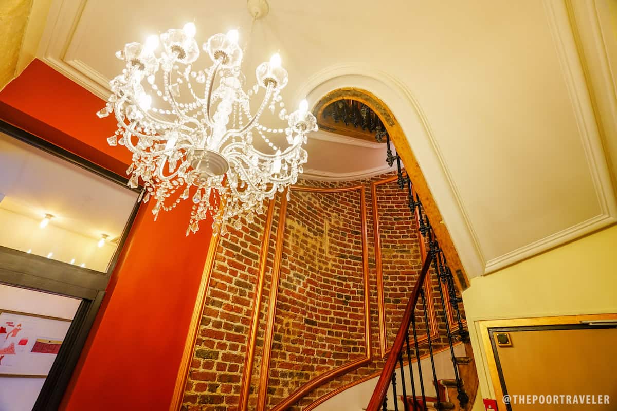 Chandelier and grand staircase, surrounded by red brick, London-style